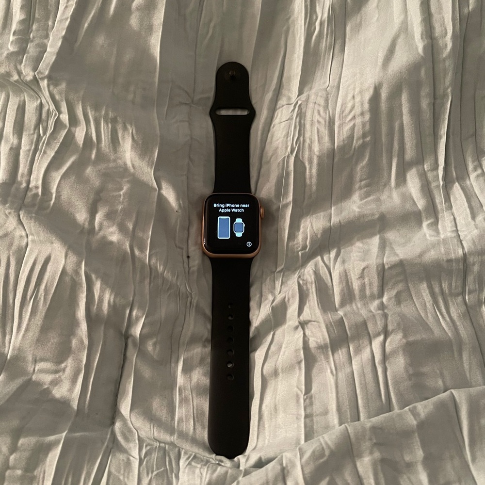 Apple Watch Series 4 Rose Gold with black band.